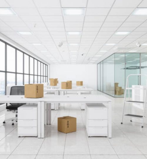 Moving To New Office With Cardboard Boxes, Office Chairs, Ladder And Empty Desks.